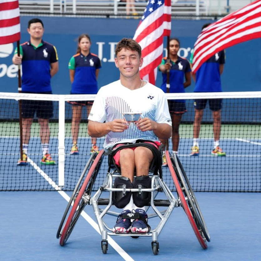 Charlie Cooper-wheelchair tennis Wheelchair tennis player Charlie Cooper poses on the court with a silver cup.
