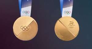 The Olympic medal design for Milano-Cortina 2026. It's a bisected disk with the Olympic rings in the center. The reverse has the Games logo and the event.